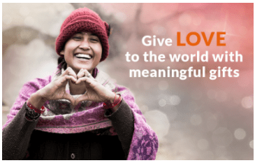 A woman is smiling and making the shape of a heart with her hands with the words "Give Love to the world with meaningful gifts"